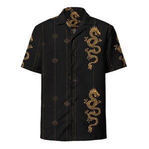 May include: Black button-down shirt with a gold dragon design. The short-sleeved shirt features a repeating pattern of gold dragons and geometric shapes. The shirt has a classic collar and a button-up front.