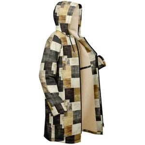 May include: A long-sleeved hooded jacket with a geometric pattern in shades of brown, beige, and black. The jacket has a zipper closure and a hood.