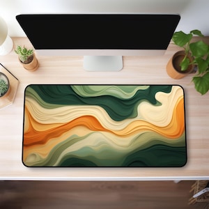 May include: Abstract mouse mat with a wavy, layered design in shades of green, orange and cream.