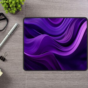 May include: Purple abstract design mouse pad with a wavy pattern.
