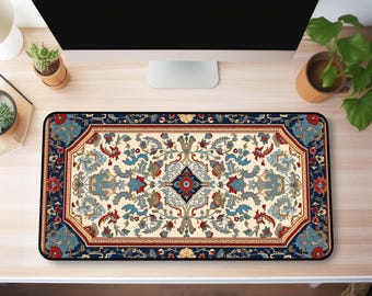 May include: A blue, red, and white patterned desk mat with a floral design. The mat is on a wooden desk with a computer monitor and a potted plant.