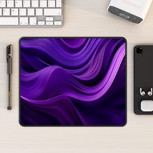 May include: Purple abstract mousepad with a wavy design. The mousepad has a black border.