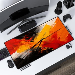 May include: A rectangular mouse mat with a black border, featuring an abstract design in red, yellow, and black. The artwork has bold brushstrokes, creating a modern look. The mat is for computer use and is approximately 91 cm long.