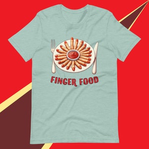 May include: A light blue t-shirt featuring a graphic of a plate of fingers with red nail polish, arranged in a circle around a small bowl of red sauce. The text "FINGER FOOD" is printed below the plate.
