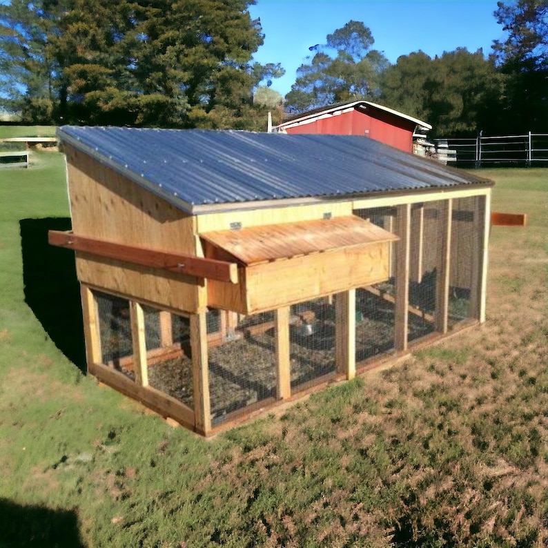 May include: A wooden chicken coop with a metal roof and a wire mesh enclosure. The coop has a nesting box and a ramp for the chickens to enter.