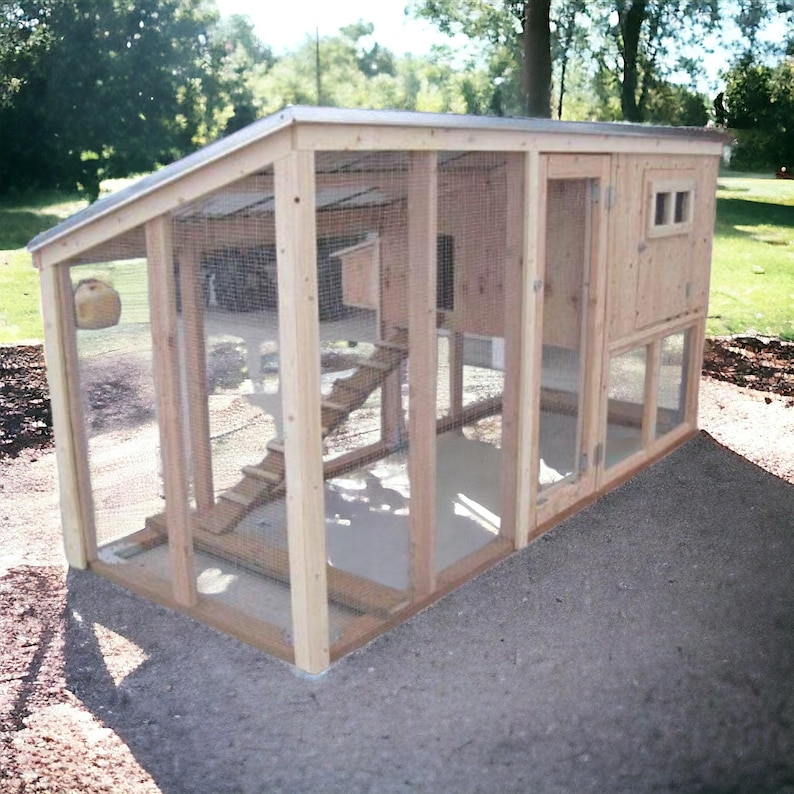 May include: A wooden chicken coop with a wire mesh enclosure. The coop has a door, a ramp, and a nesting box. The coop is sitting on a gravel surface.