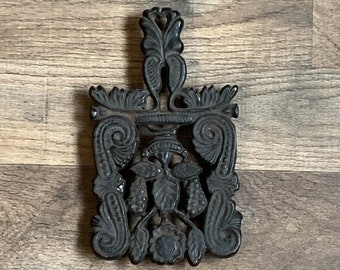 Cast iron trivet, footed scroll & grape leaf