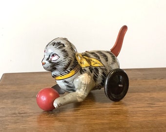 Vintage Marx tin litho kitty cat toy with ball, gray tabby w/ red tail, missing ears, works