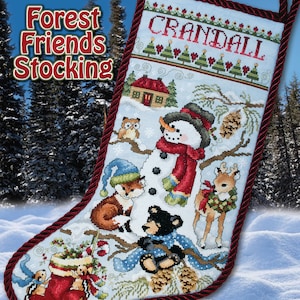 May include: A cross-stitch pattern for a Christmas stocking featuring a snowman, a fox, a bear, and a deer in a winter forest scene. The stocking is decorated with a red and white candy cane, pine cones, and a blue and white scarf. The pattern is titled "Forest Friends Stocking" and includes the name "Crandall".