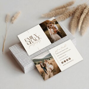 May include: A business card with a brown and white colour scheme. The card features a logo for Emily Grace Photography, along with contact information and social media handles. The card also includes two photos of a couple in a field.