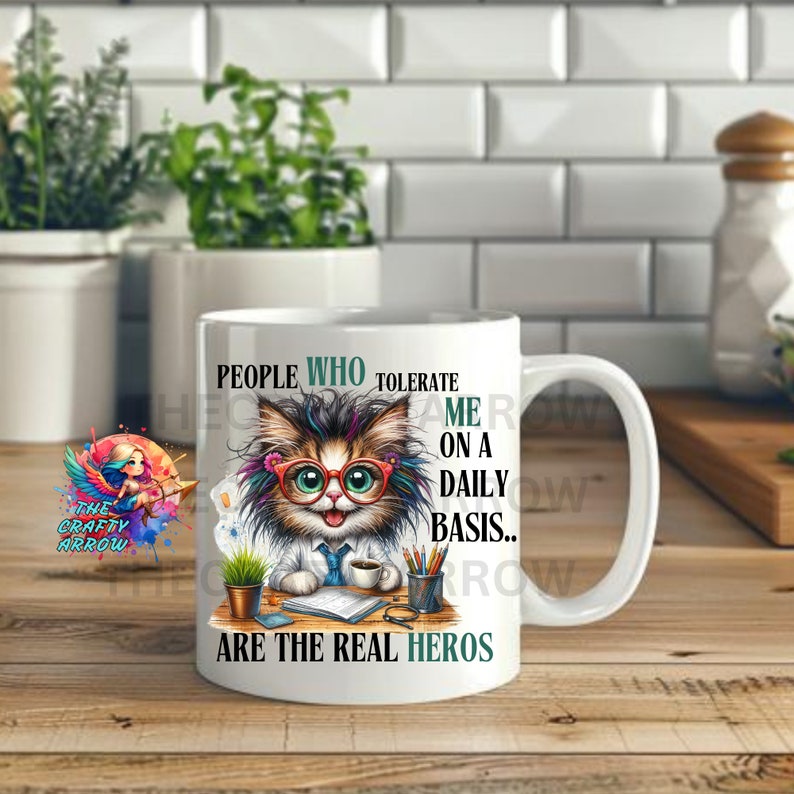 May include: White ceramic coffee mug with a colorful illustration of a cat wearing glasses and a doctor's coat. The text on the mug reads "People who tolerate me on a daily basis... are the real heros".