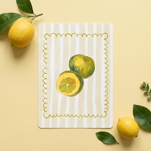 May include: A rectangular card featuring a painted illustration of two lemons, one whole and one halved, centered within a scalloped border. The background of the card consists of vertical beige and white stripes, creating a textured appearance.
