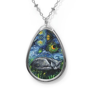 May include: A silver chain necklace with a teardrop-shaped pendant featuring a painting of a cat sleeping under a starry night sky.