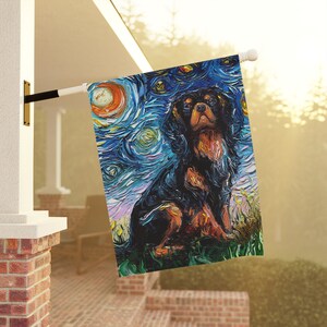 May include: A black and brown Cavalier King Charles Spaniel dog is painted in a starry night style. The dog is sitting and looking at the viewer. The background is a blue and purple sky with white stars.