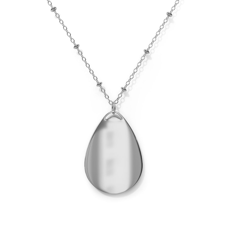 May include: A silver-toned necklace featuring a teardrop-shaped pendant. The pendant is smooth and reflective, suspended from a delicate chain with small, round beads. The necklace is displayed against a white background.