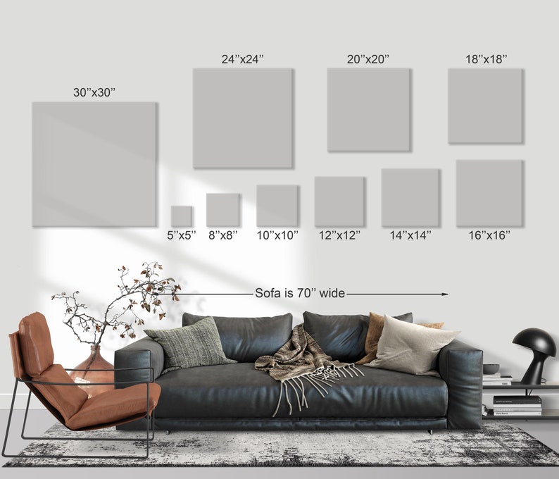 May include: A display of various sized square canvas art prints, ranging from 5x5 inches to 30x30 inches. The text indicates the sofa is 70 inches wide. The canvas prints are displayed on a white wall above a black leather sofa.