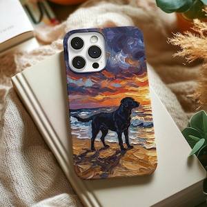 May include: A phone case featuring a painting of a black dog standing on a beach at sunset. The artwork depicts a vibrant sky with orange, purple, and blue hues. The case has a dark blue border and a glossy finish.