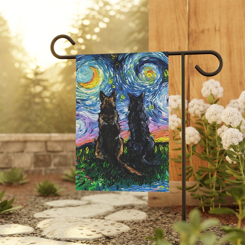 May include: A garden flag featuring a painting of two dogs silhouetted against a starry night sky, reminiscent of Van Gogh's style. The dogs are seated on a grassy hill, with vibrant colors in the sky and foreground.