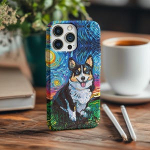 May include: A phone case featuring a corgi dog design in the style of Van Gogh's "Starry Night." The case has a blue, yellow, and purple starry sky background. The corgi is black, white, and brown, with its tongue sticking out. The case is on a wooden surface.