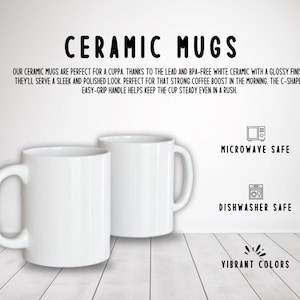 May include: Two white ceramic mugs with C-shaped handles. The mugs are microwave and dishwasher safe. The text "CERAMIC MUGS" is at the top of the image. The text "MICROWAVE SAFE", "DISHWASHER SAFE", and "VIBRANT COLORS" is at the bottom of the image.
