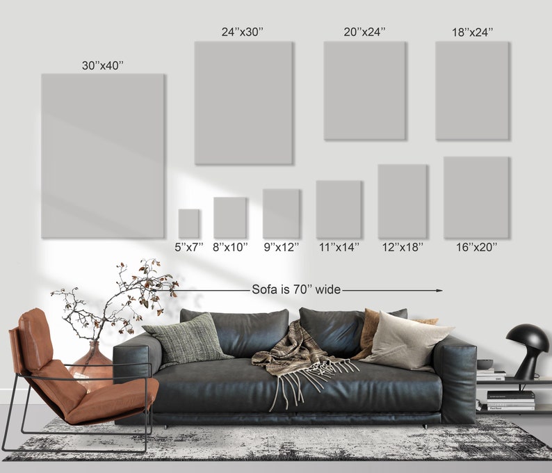 May include: A display of various sized blank canvas art prints, including 30"x40", 24"x30", 20"x24", 18"x24", 16"x20", 12"x18", 11"x14", 9"x12", 8"x10", and 5"x7". The sofa is 70" wide.