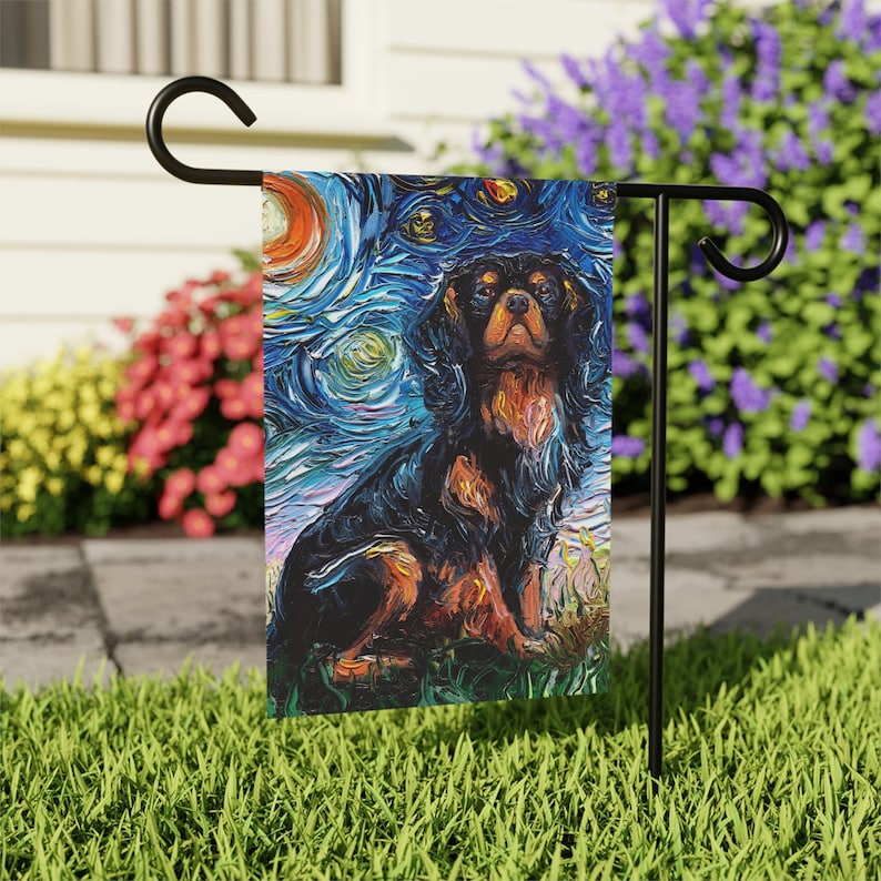 May include: A garden flag featuring a black and brown Cavalier King Charles Spaniel dog painted in a style reminiscent of Vincent van Gogh's "Starry Night". The flag has a blue, yellow, and white background with swirling brushstrokes.