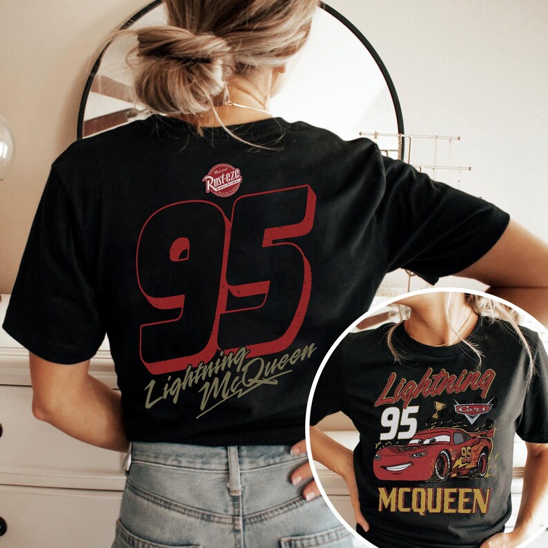 May include: Black t-shirt featuring a large red number 95 with a shadow effect and the words "Lightning McQueen" in a stylized font. The shirt also has the "Rusteze" logo. A smaller image of the shirt is visible in the lower right corner.