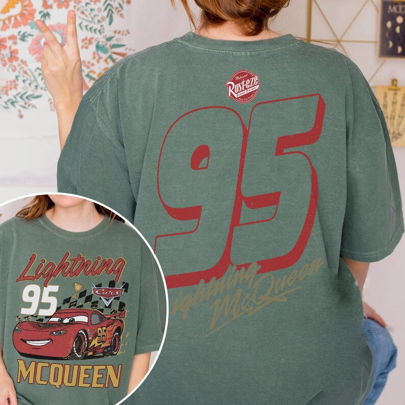 May include: Green t-shirt featuring a large red number 95 on the back, with the text "Lightning McQueen" below. The front of the shirt displays a graphic of Lightning McQueen and the text "Lightning 95 McQueen".
