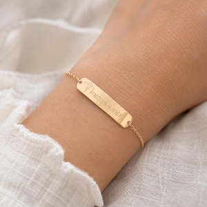 May include: A gold-toned medical alert bracelet featuring a thin chain and a rectangular metal bar. The bar is engraved with a medical caduceus symbol and the text PENICILLIN ALLERGY in clear, capitalized sans-serif lettering.