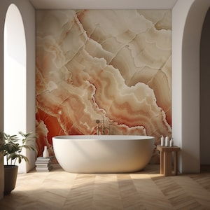 May include: A contemporary bathroom with a white oval bath, a wooden side table with toiletries, and a large wall with a red and beige marble design. The room has a wooden floor and an arched doorway.