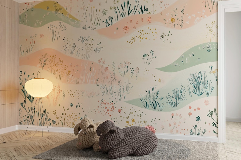 May include: A nursery room with a light pink and green floral wallpaper, a white floor lamp with a white shade, and two knitted bunny toys on the floor.