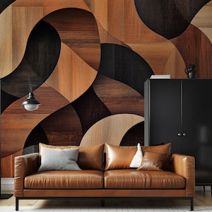 May include: A brown leather sofa with three pillows sits in front of a wall with a geometric pattern of brown and black wood panels.