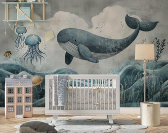 May include: A nursery scene with a white crib, a whale-themed mural, and a plush whale toy on a round rug. The mural features a large blue whale, jellyfish, and ocean waves. A dollhouse and a floor lamp complete the room.