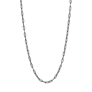 May include: A simple silver chain necklace with a delicate, linked design.