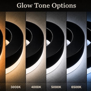 K&ouml;nnte beinhalten: Eine kreisf&ouml;rmige schwarze Leuchte mit sechs Glow Tone Options von 2000K bis 8000K. Die Lichtabgabe reicht von einem warmen Bernsteinton bei 2000K &uuml;ber neutrales Wei&szlig; bei 5000K bis hin zu einem k&uuml;hlen, bl&auml;ulichen Wei&szlig; bei 8000K.