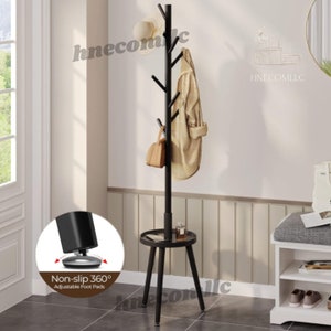 May include: Black metal coat rack with a tree branch design and a small round shelf. The rack has six hooks and adjustable non-slip foot pads.