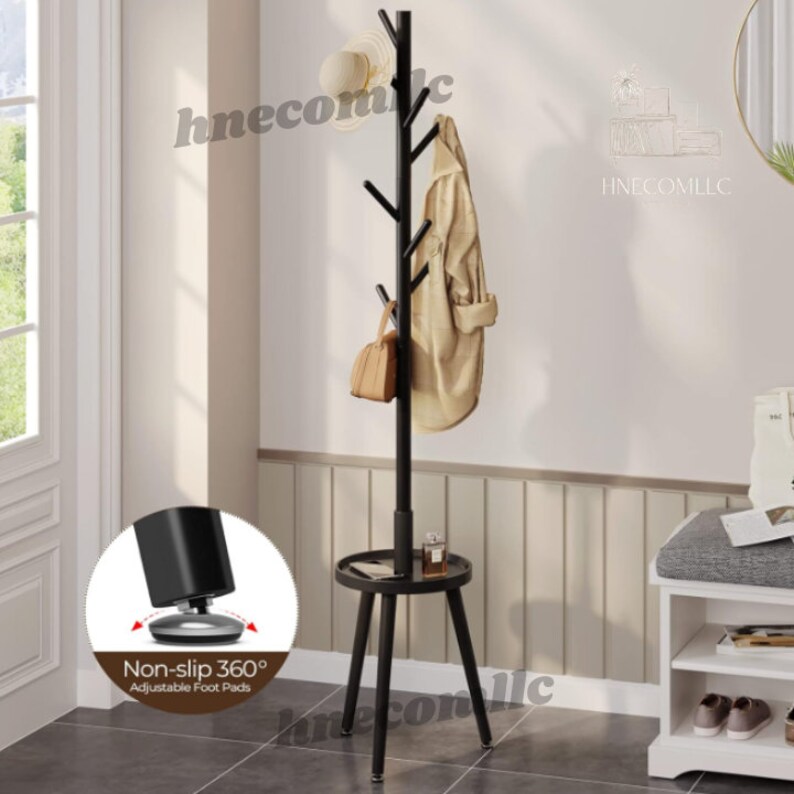 May include: Black metal coat rack with a tree branch design and a small round shelf. The rack has six hooks and adjustable non-slip foot pads.