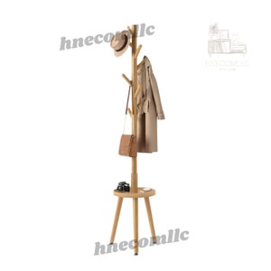 May include: A wooden coat rack with a round shelf and three legs. The rack has multiple branches for hanging items like coats, hats, and bags. A hat, coat, and purse are hanging on the rack.