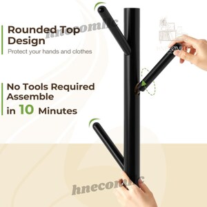 May include: Black metal coat rack with a tree branch design. The rack has rounded tops to protect hands and clothes. The rack is easy to assemble and requires no tools. The text "No Tools Required Assemble in 10 Minutes" is visible in the image.