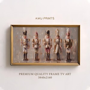 May include: A framed print of five toy soldier nutcrackers. The nutcrackers are painted in gold, white, and red. The artwork is in a gold-coloured frame. The text "KIKU PRINTS" is at the top. The text "PREMIUM QUALITY FRAME TV ART" is at the bottom.