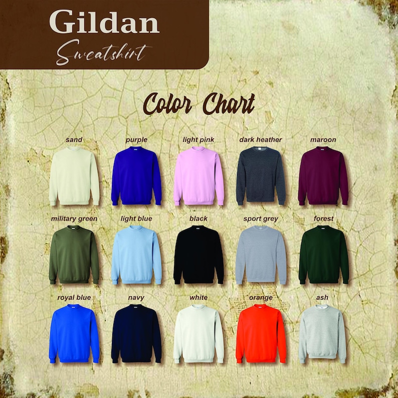 May include: Color chart for Gildan sweatshirts showing 15 different colors: sand, purple, light pink, dark heather, maroon, military green, light blue, black, sport grey, forest, royal blue, navy, white, orange, and ash.