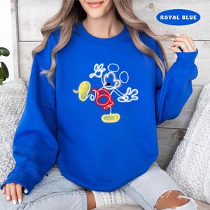 May include: A royal blue sweatshirt with a white outline of Mickey Mouse in a neon yellow and red color scheme.