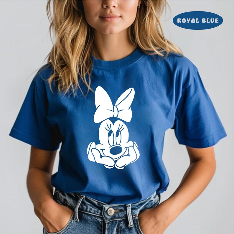 May include: A royal blue t-shirt with a white graphic of Minnie Mouse with a bow. The text "ROYAL BLUE" is in the upper right corner of the image.
