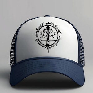 May include: A navy blue and white trucker hat featuring a black graphic of a sword, tree, and inscription. The hat has a curved brim and mesh back. The design is centered on the front panel.