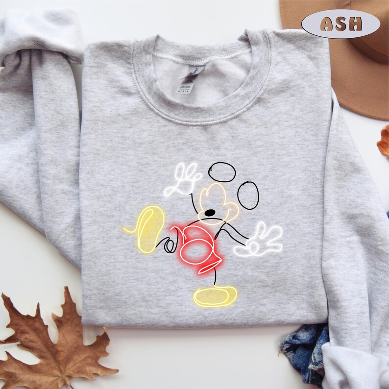 May include: A gray sweatshirt with a white outline of Mickey Mouse in a neon yellow, red, and white color scheme.