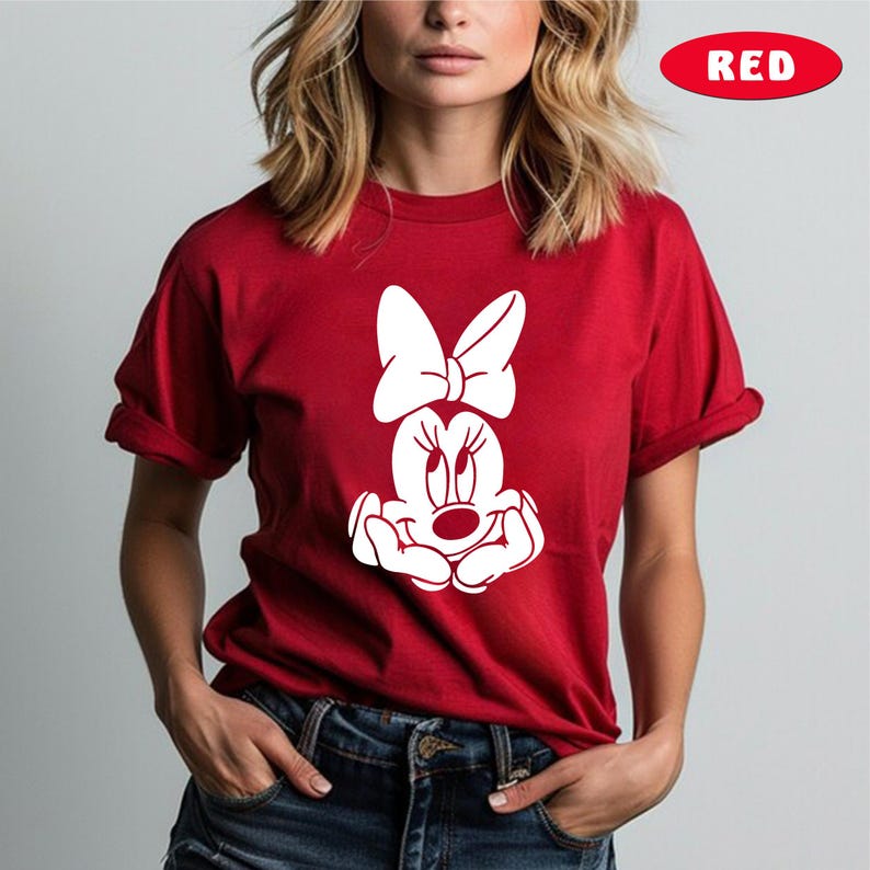 May include: Red t-shirt with a white graphic of Minnie Mouse with a bow.