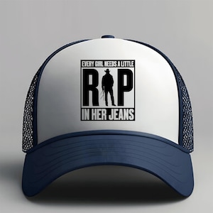May include: A white and navy blue trucker hat with a curved brim. The hat features a graphic with the text "EVERY GIRL NEEDS A LITTLE R&P IN HER JEANS" in a black rectangle, with a silhouette of a person.