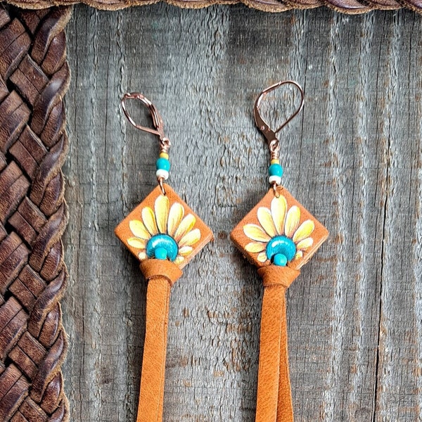 6" earrings hand painted on repurposed leather with deerskin lace ties. Dyed Howlite beaded accents and copper lever back ear wires.