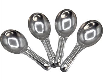 May include: Four shiny, silver metal scoops with oval bowls and long, flat handles. The scoops are arranged in a fan shape, with the bowls facing upwards. The handles have a small, round hole at the end.