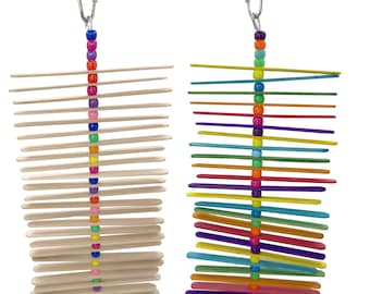 May include: Two bird toys with wooden sticks and colorful beads. One toy has natural wood sticks, the other has painted sticks in various colors. Both toys have a metal clip for hanging and a small ring at the bottom.